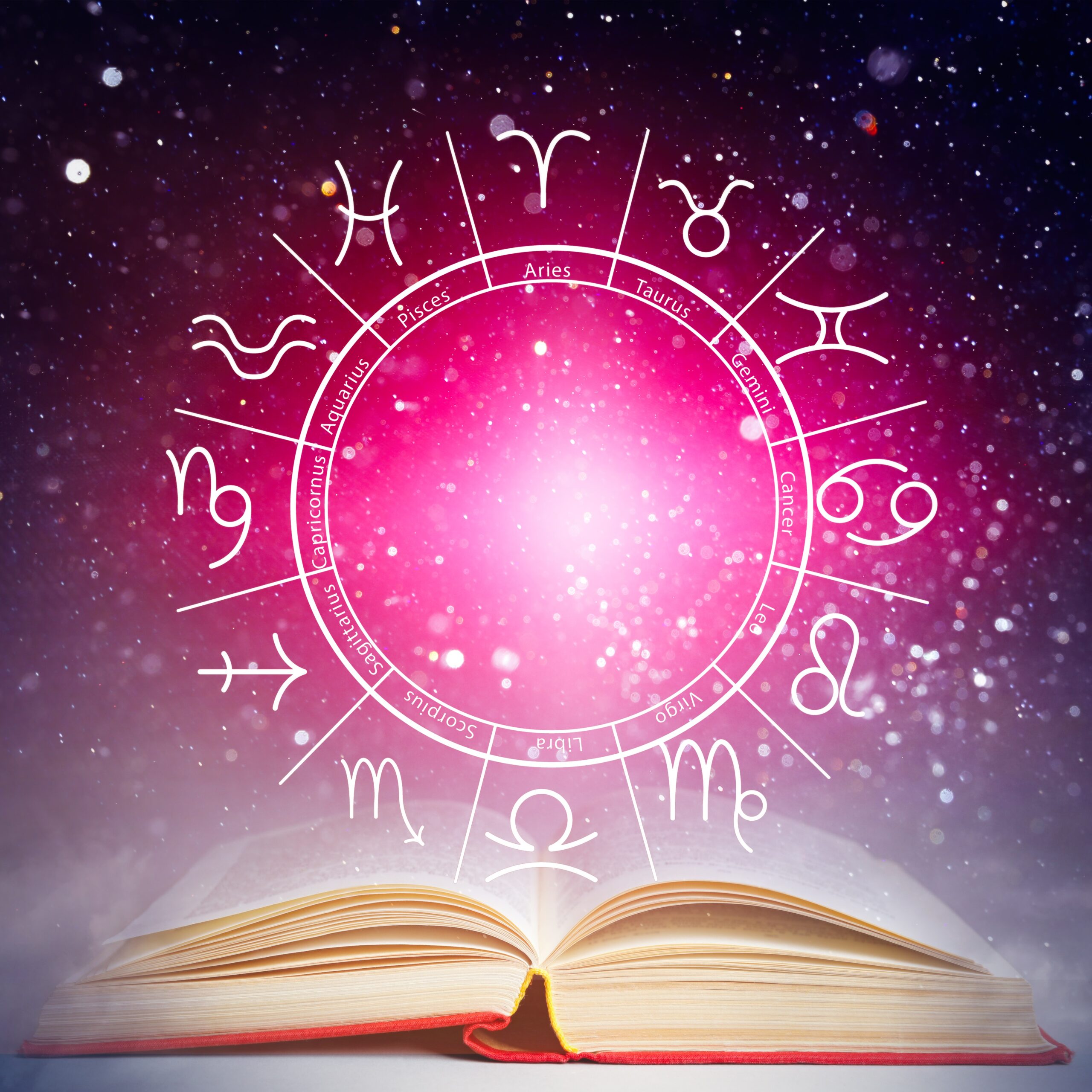 Open book with pink astrological wheel & signs floating above it against a starry night sky