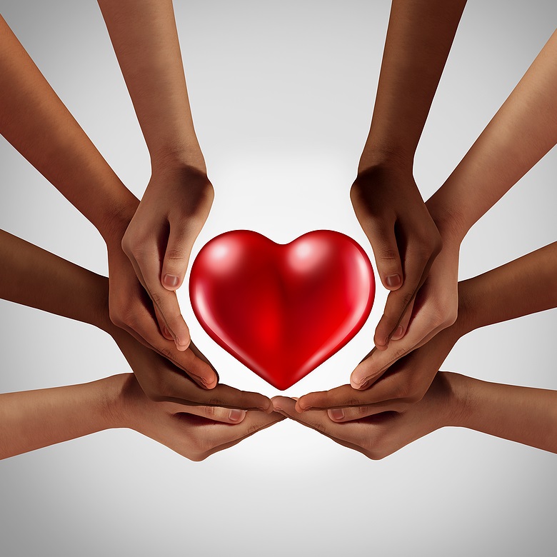 Hands of diverse races creating circle around a heart