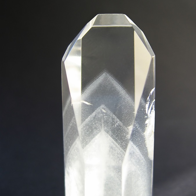 Black & white photo of phantom quartz which has shadows of other crystals within it