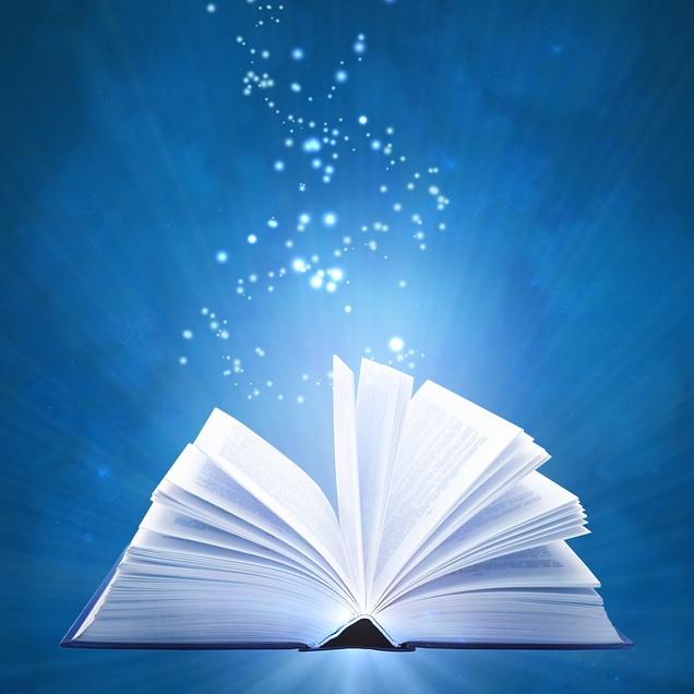 Illuminated open book with sparkles floating out of it against blue background