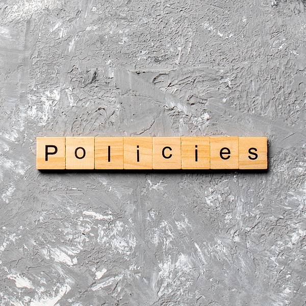 The word Policies is spelled out with wooden blocks