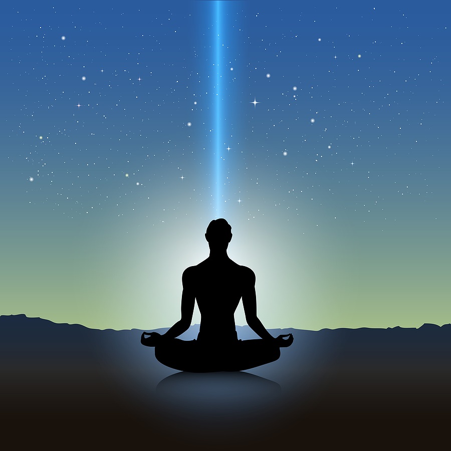 Silhouette of seated figure with ray of blue light coming down into crown chakra and surrounding person