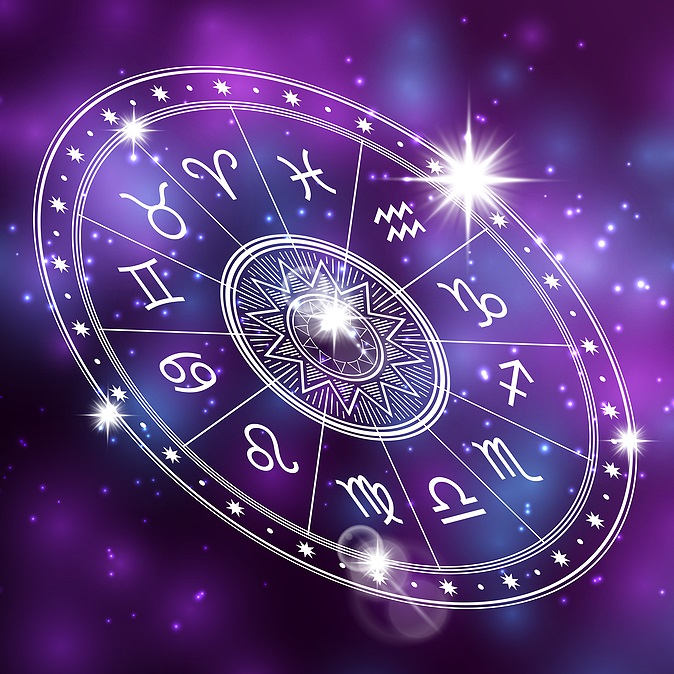 White astrological chart showing signs against a background of brilliant purple light and stars