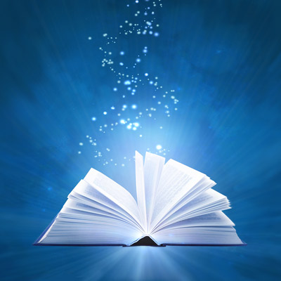 Illuminated open book with sparkles floating out of it against blue background
